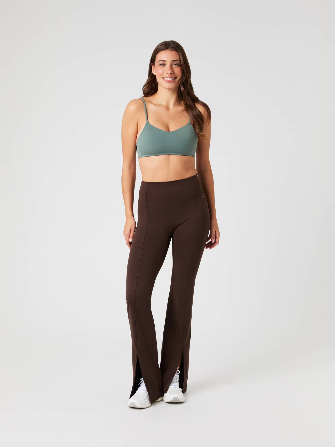 Front view of a model in Molé (Brown) Studio Flared Slit Tights with a stylish flared fit and tonal logo for training. - Image 2