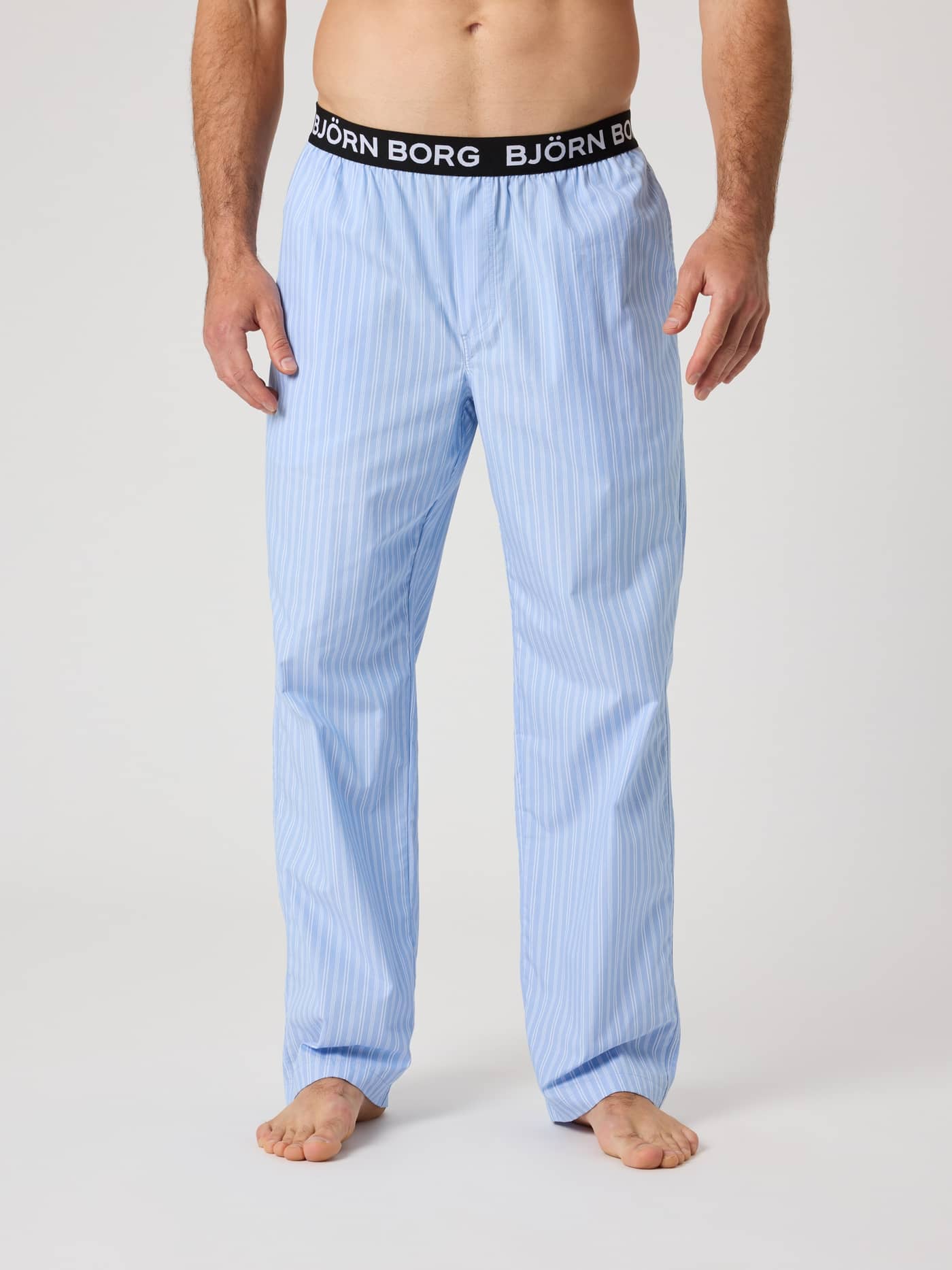 Front view of striped Björn Borg Core Woven Logo Pyjama Pants in Anglo Stripe 2 (Blue) with a white logo waistband. - Image 2