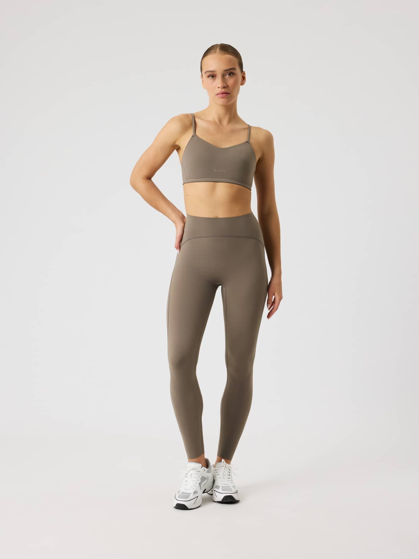 Full-body front view of a model in the brown Björn Borg Studio Soft Padded Bra, designed for training style and fit. - Image 3