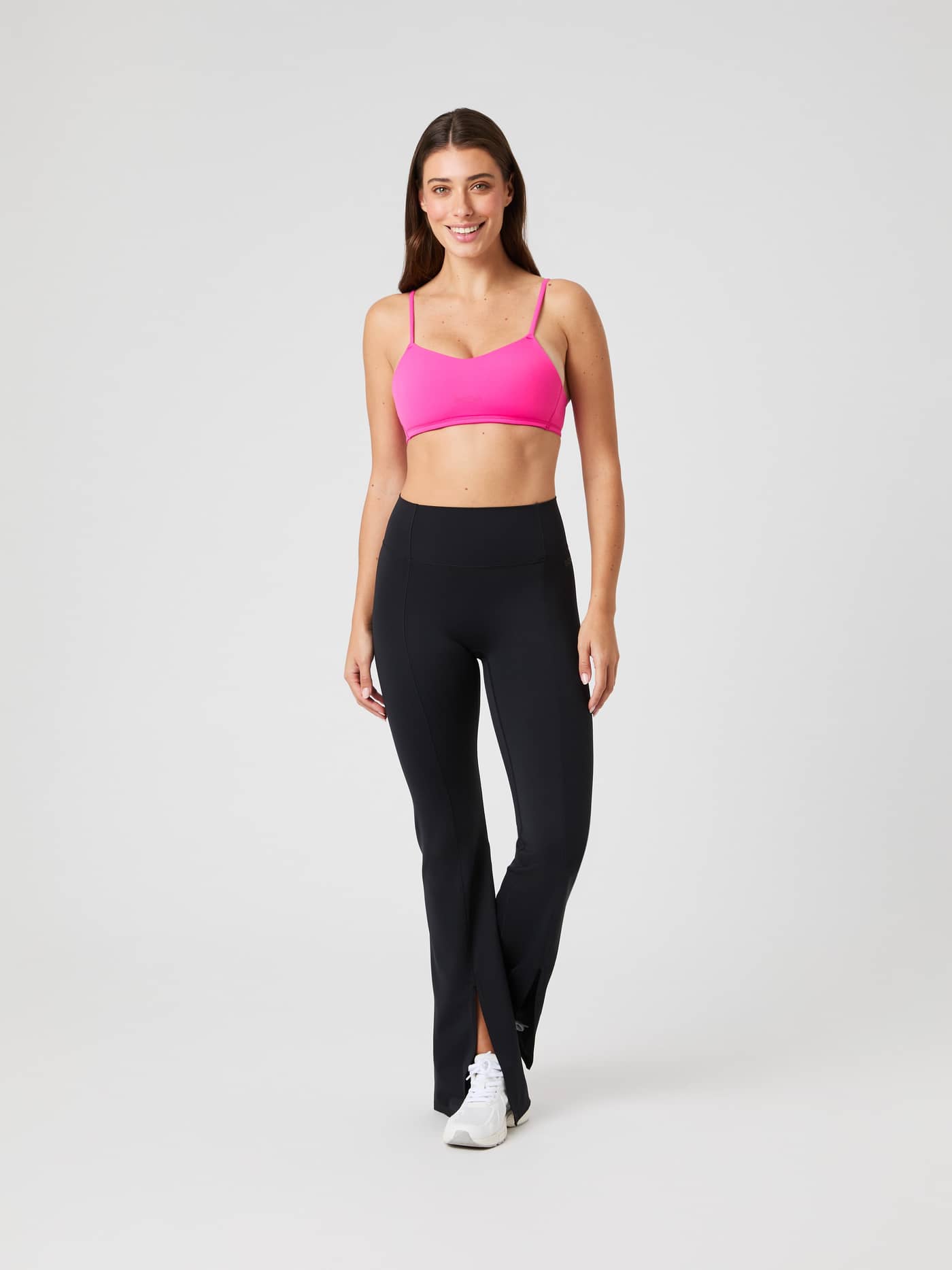 Full-body front view of a model wearing the pink Studio Soft Padded Bra, designed for a stylish fit during training. - Image 3
