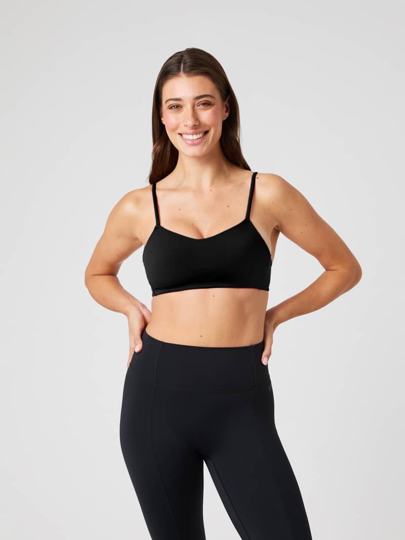 Front view of a model wearing the black Björn Borg Studio Soft Padded Bra, offering a stylish and supportive training fit.