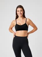 Front view of a model wearing the black Björn Borg Studio Soft Padded Bra, offering a stylish and supportive training fit.