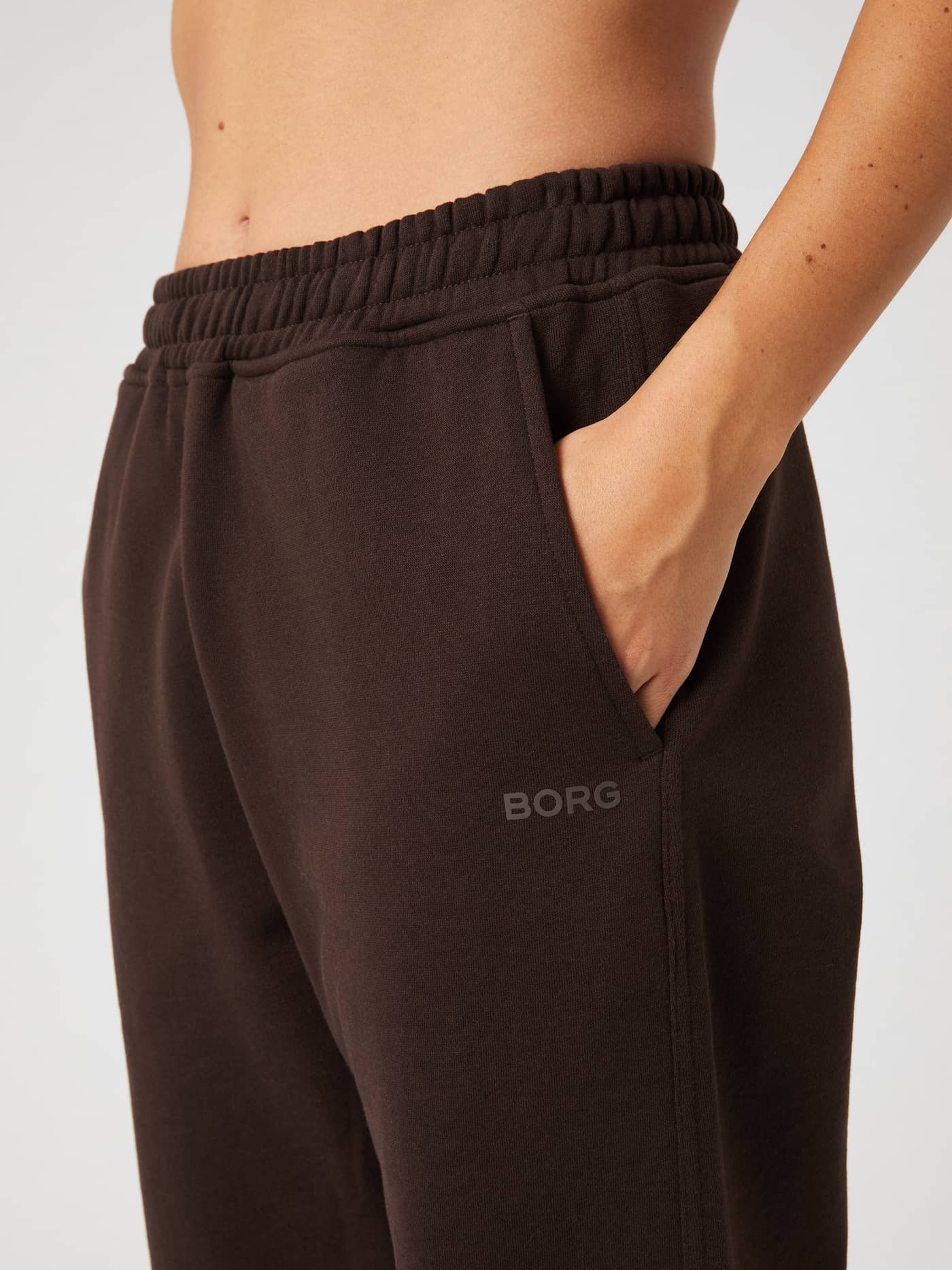 Close-up on the Molé brown Studio Oversized Straight Sweatpants showing the pocket, elastic waistband, and tonal BORG logo. - Image 4
