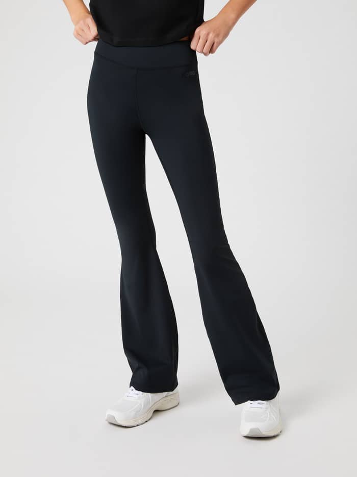 Front view of kids wearing Black Beauty (Black) Borg Flare Leggings with a flared leg and tonal logo for training.