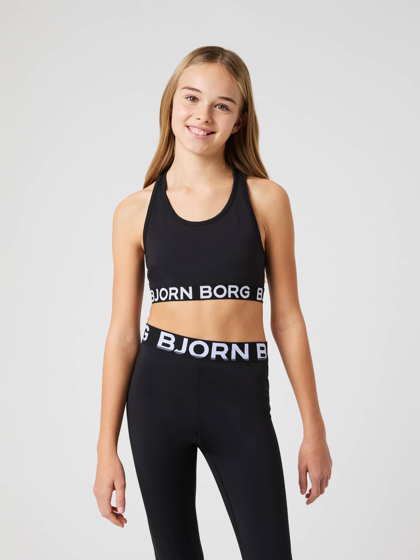 Borg Sports Top i Black Beauty (Svart) til trening for kids sett forfra, med hvit logo og støttende passform. - Image 1