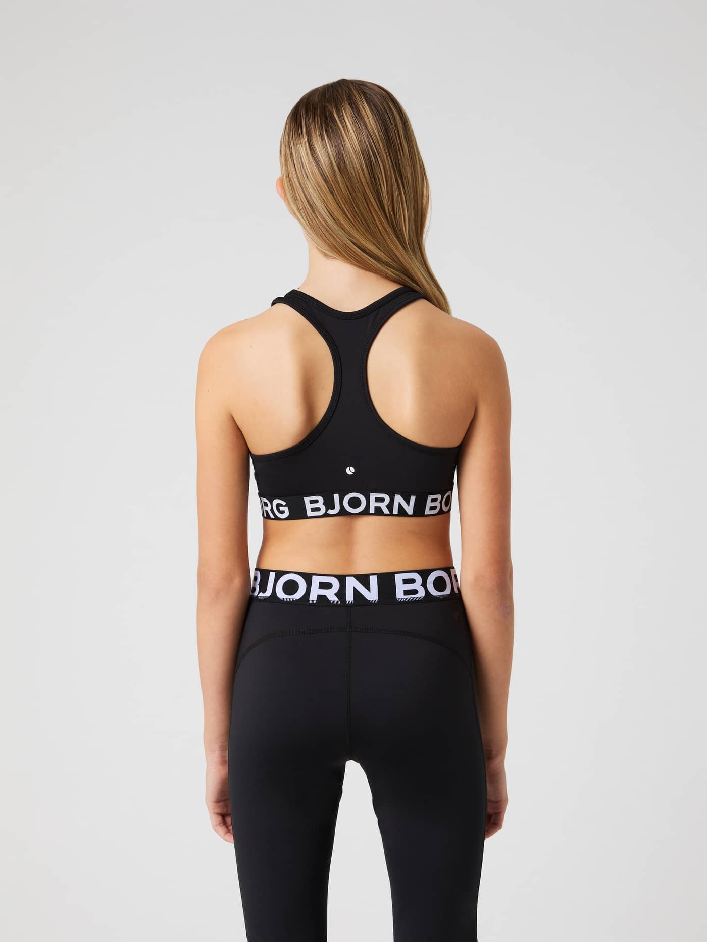 Back view of the black Björn Borg Sports Top for kids, featuring a white logo elastic and racerback for training. - Image 2