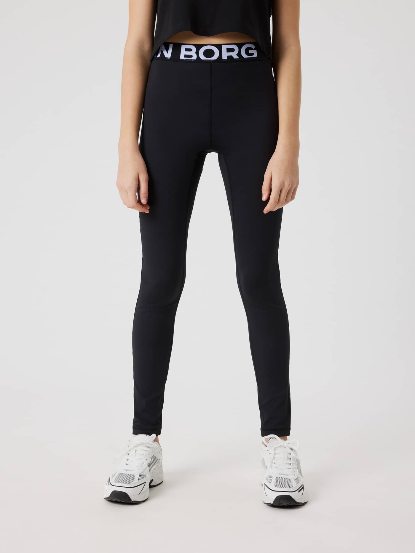Front view of kids wearing Black Beauty (Black) Borg Leggings for training, featuring a white logo waistband. - Image 1
