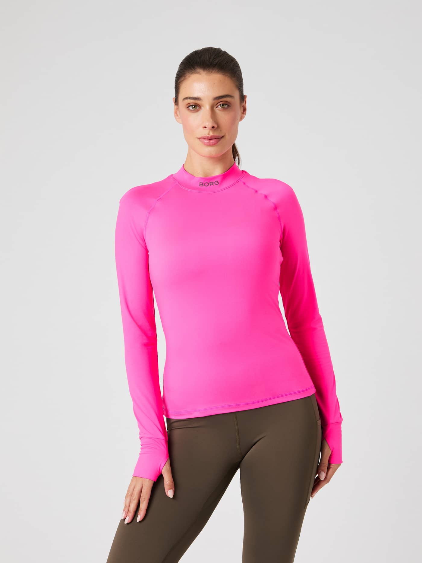 Front view of a model in the Pink Glo (Pink) Borg Performance Brushed Mockneck, a slim-fit running top with a dark logo. - Image 1