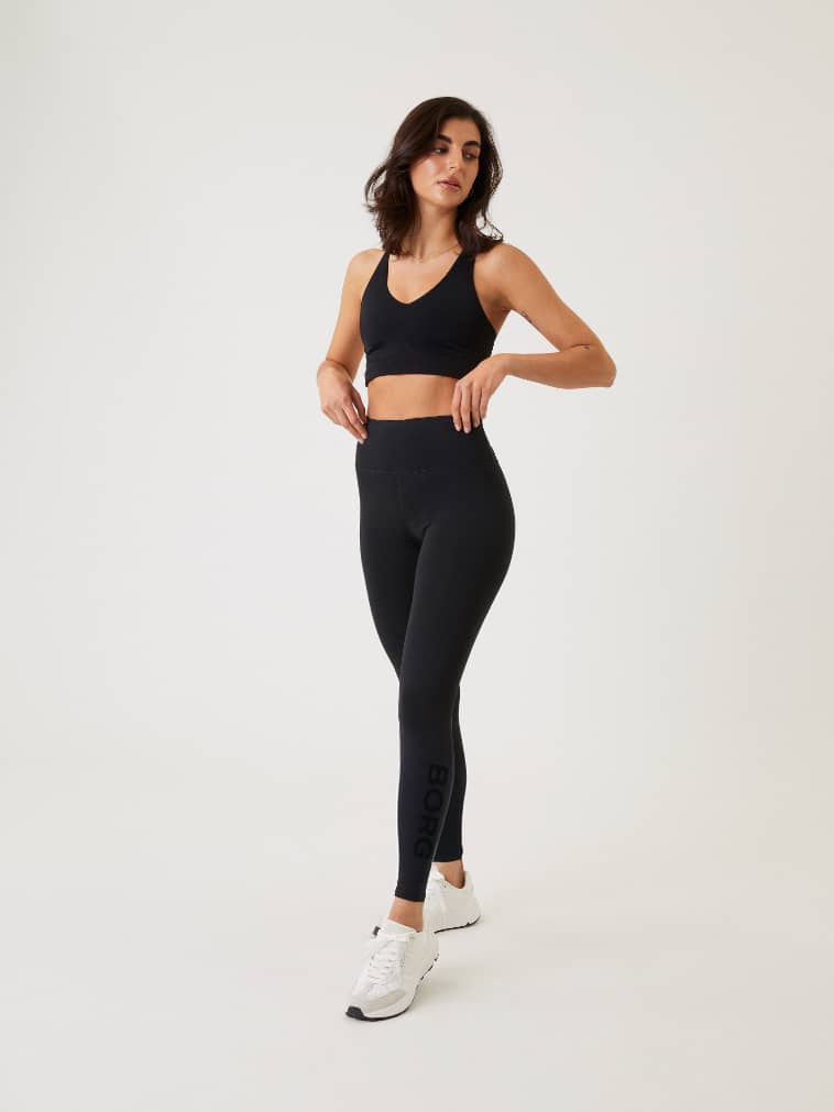 Full-body front view of a woman in high-waisted Borg Logo Tights in Black Beauty (Black) with a black logo for training. - Image 3