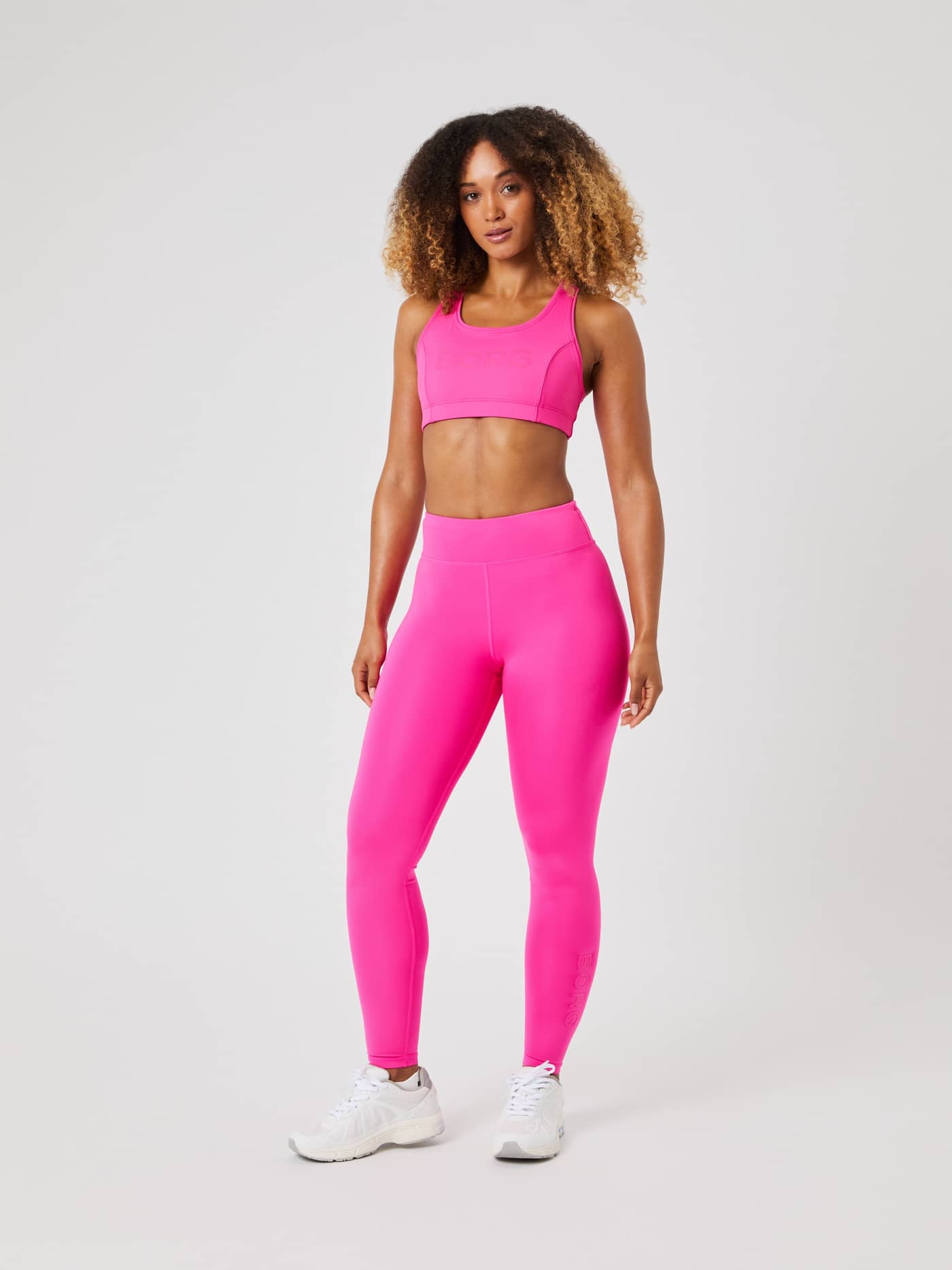 Full-body front view of a woman wearing Björn Borg Logo Tights in Pink Glo (Pink) for a stylish training fit. - Image 3