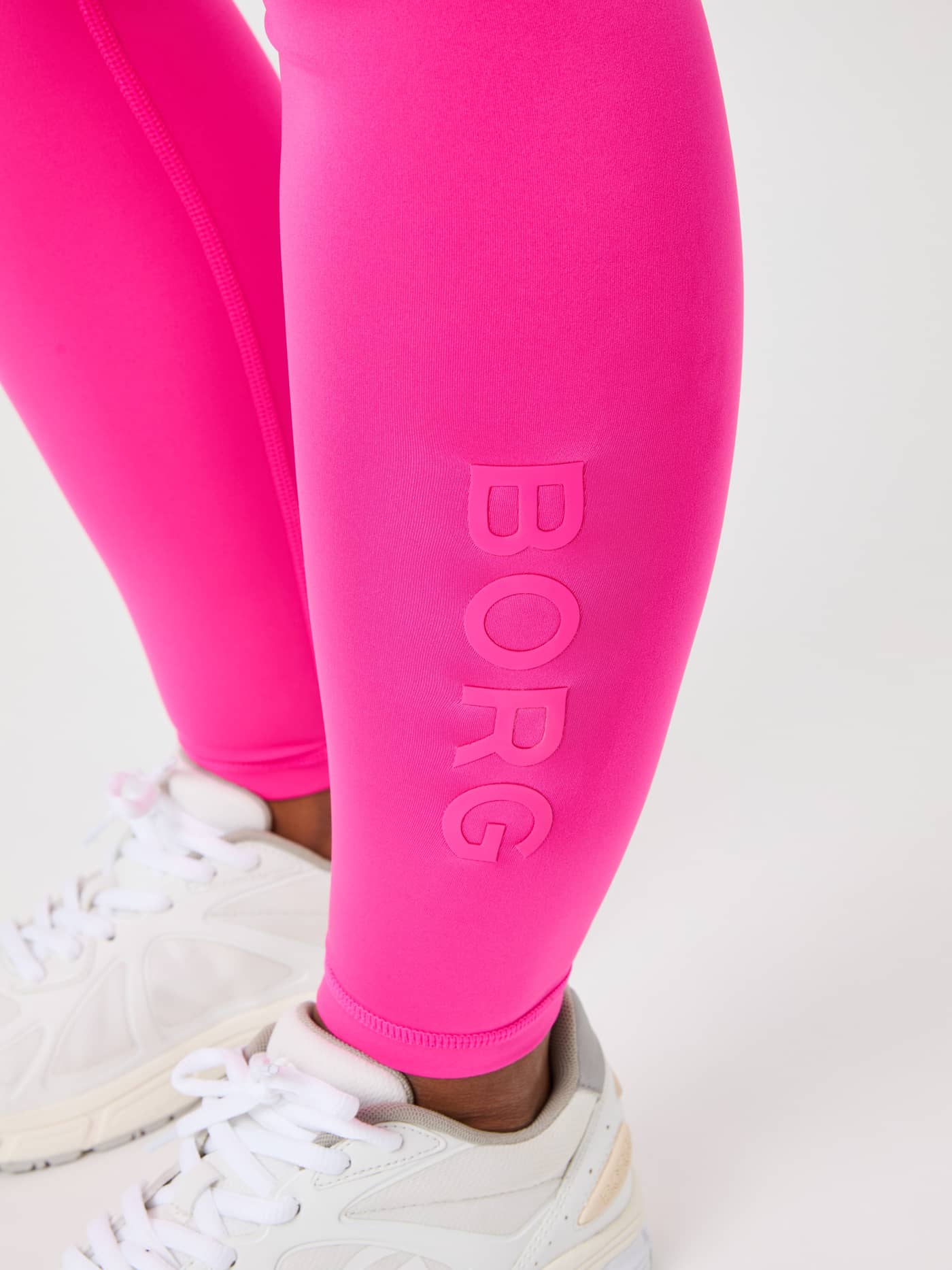 Close-up of the tonal pink logo on the Borg Logo Tights in Pink Glo (Pink), featuring a performance fit for training. - Image 5