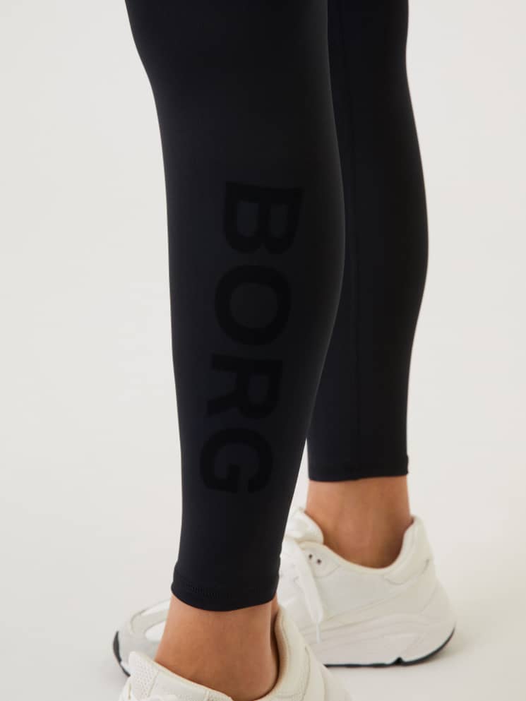 Close-up of the Borg Logo Tights in Black Beauty (Black), showcasing the stylish tonal logo and performance training fit. - Image 4
