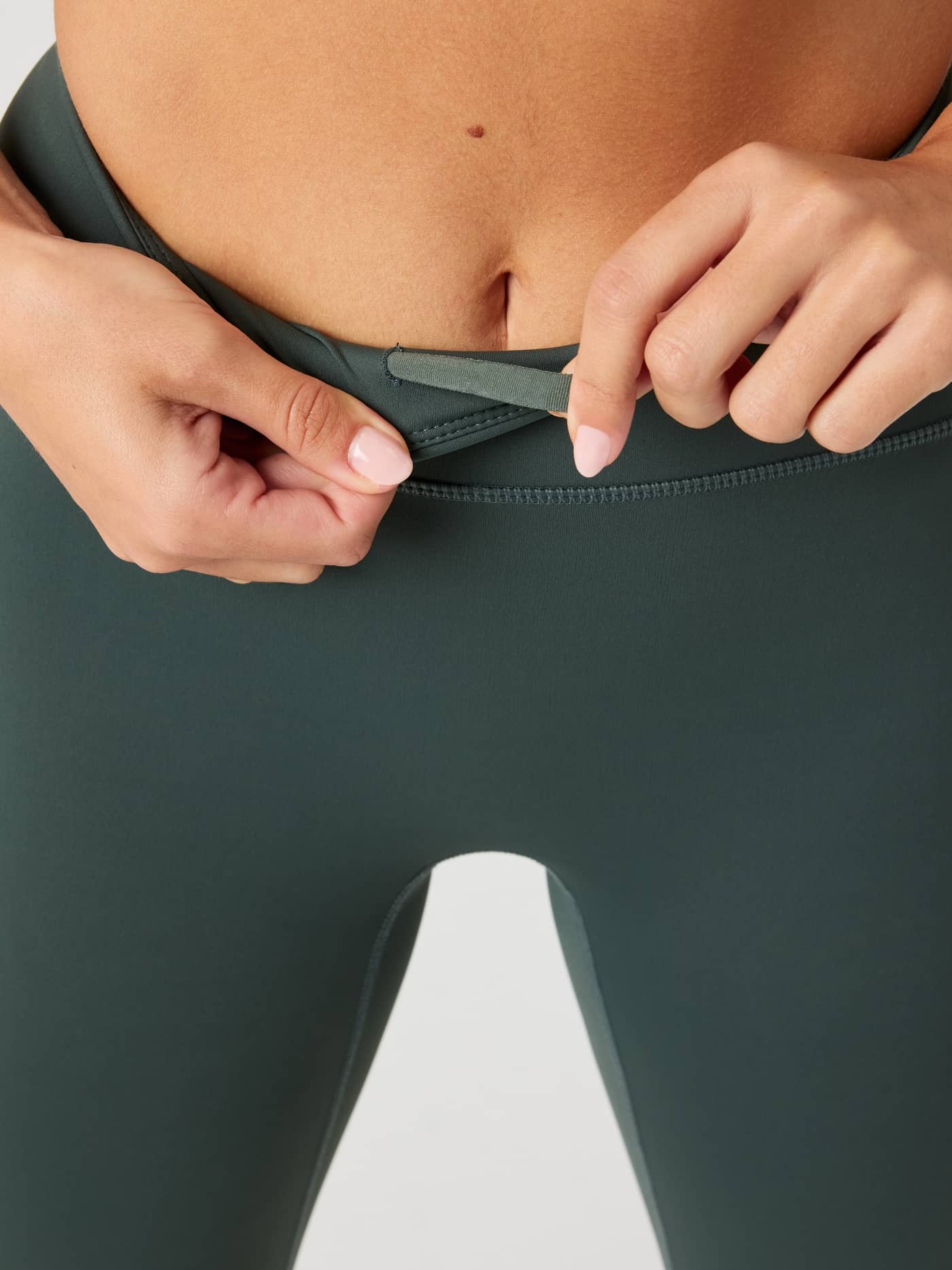 Close-up of the Urban Chic (Green) Borg Reform Tights, highlighting the shaped waistband for a supportive training fit. - Image 5