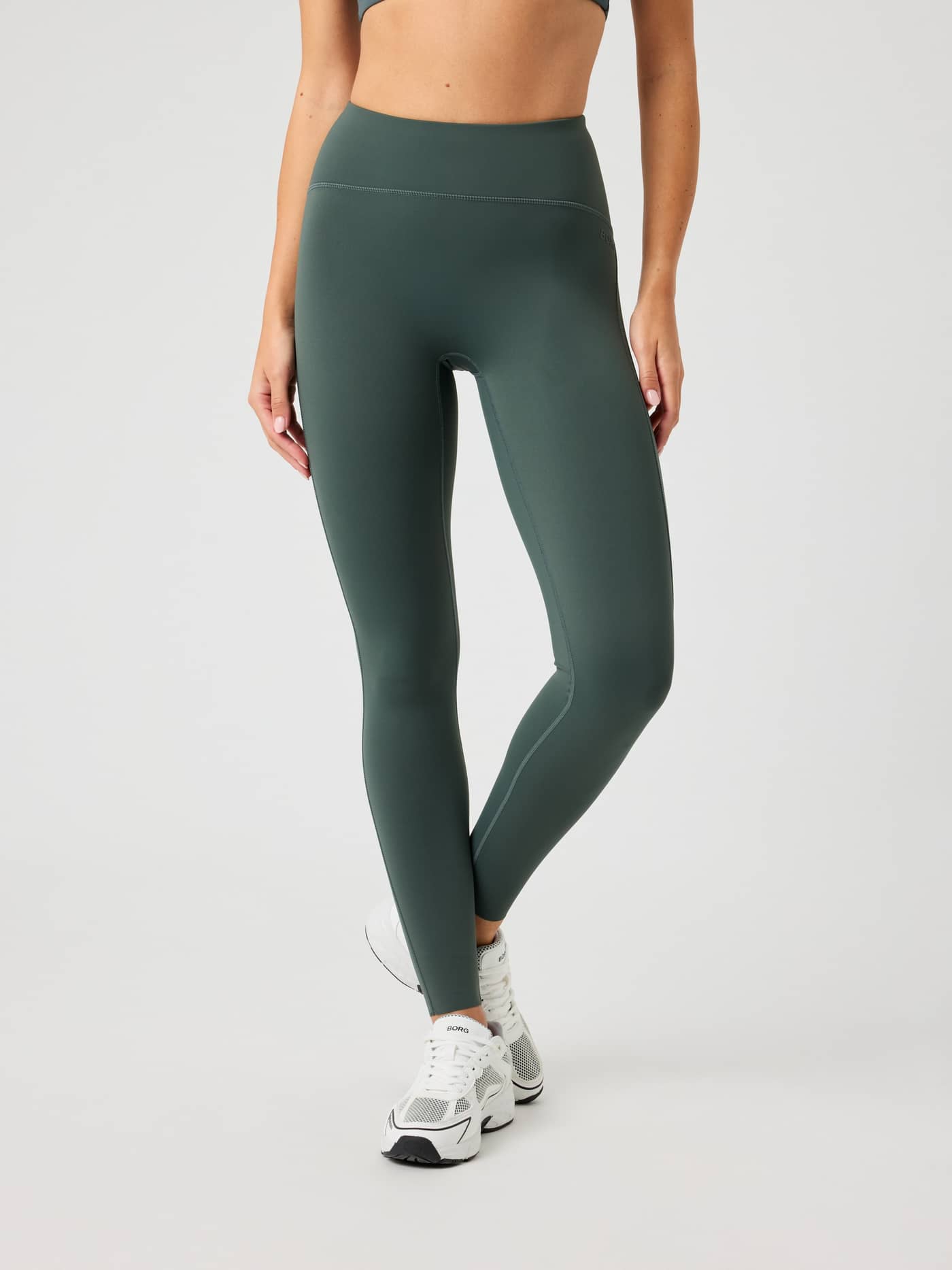 Front view of the high-waisted Borg Reform Tights in Urban Chic (Green), offering a stylish and flattering training fit. - Image 1