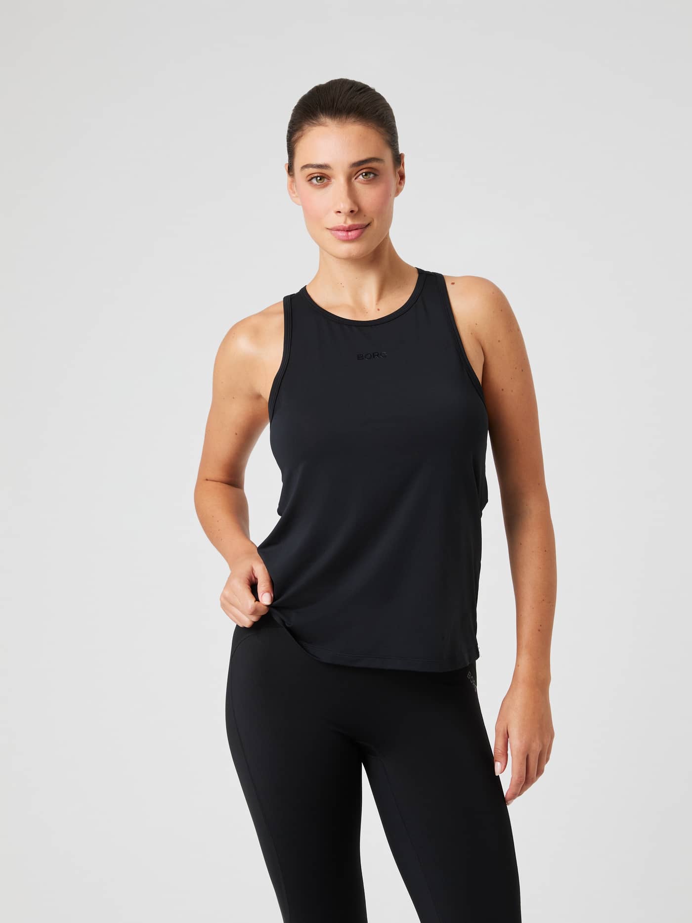 Front view of a model wearing the black Borg Sports Tank Top. - Image 1