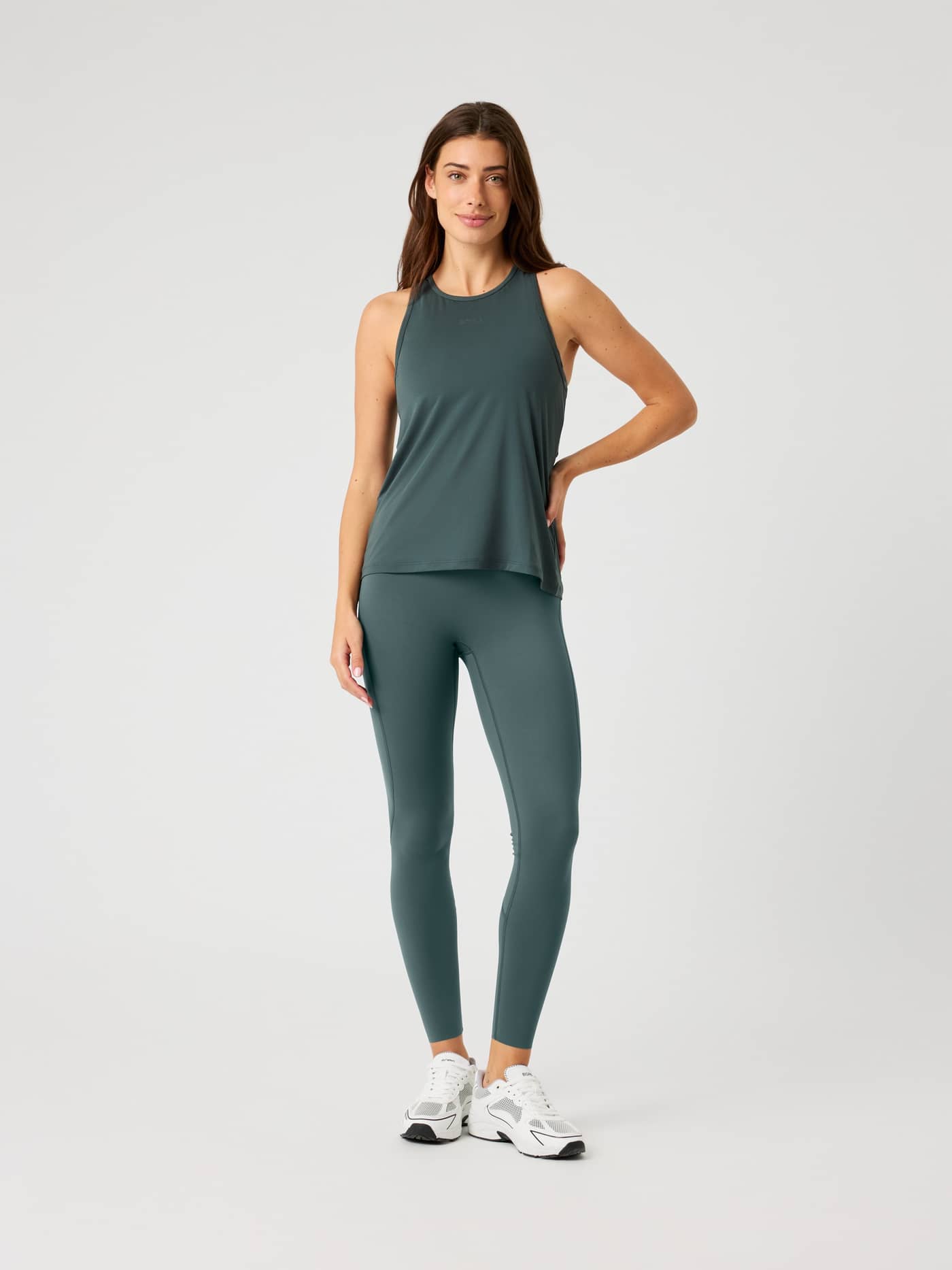 Full-body front view of a woman wearing the Urban Chic (Green) Borg Sports Tank Top, a training essential with a sleek fit. - Image 3