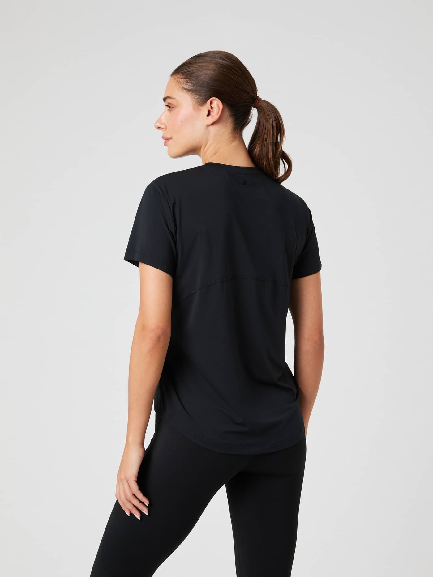 Back view of a woman in the Borg Sports T-Shirt in Black Beauty (Black), a breathable training top with a flattering fit. - Image 2