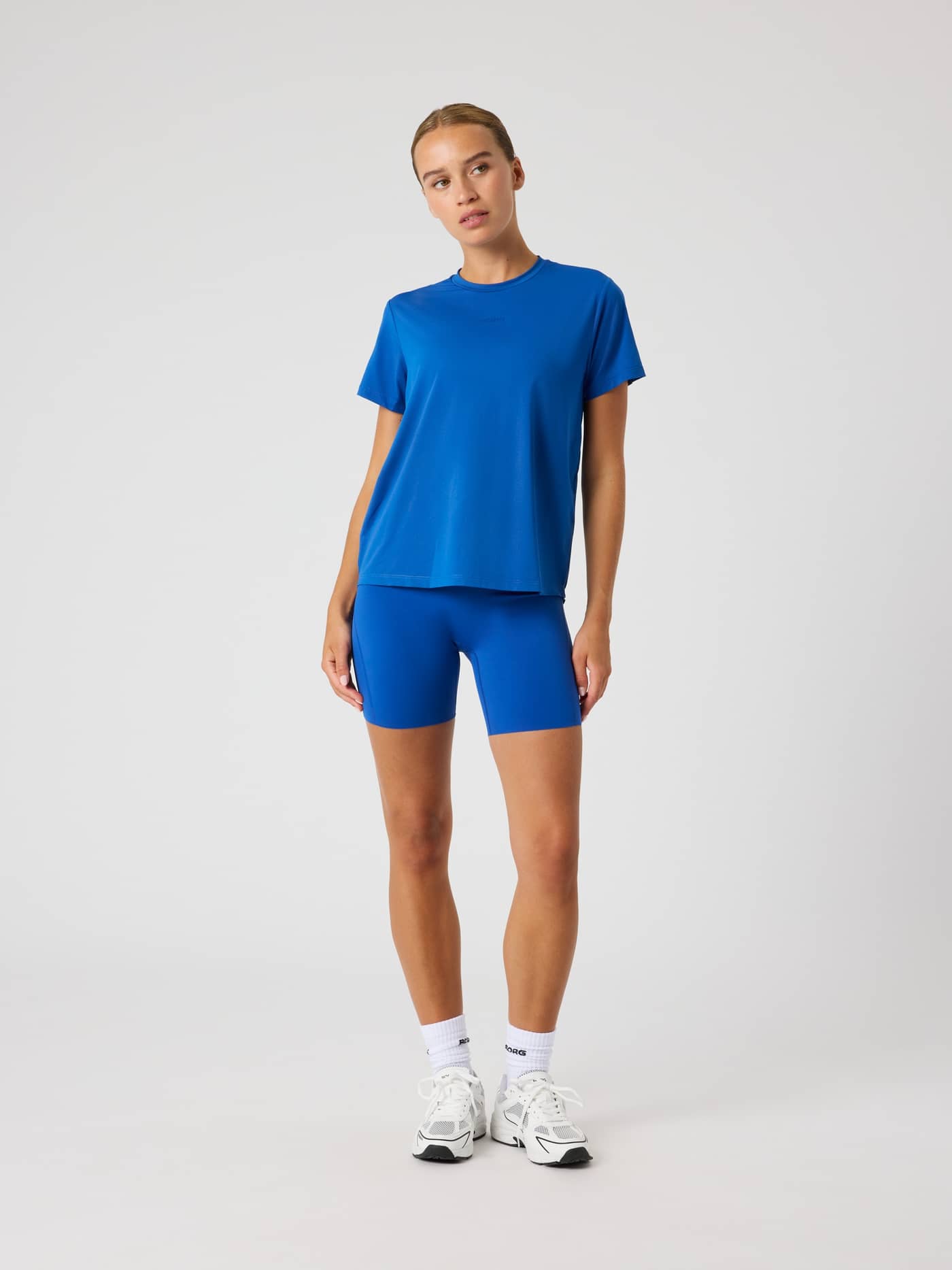 Full-body front view of a woman wearing the Monaco Blue (Blue) Borg Sports T-Shirt, a stylish, flattering fit for training. - Image 3