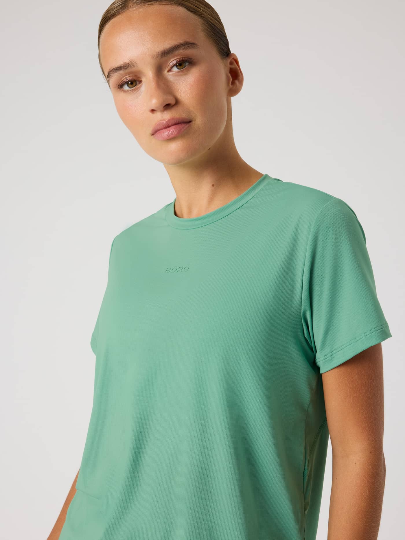 Front view of the Malachite Green (Green) Borg Sports T-Shirt, a breathable performance training top with a green logo. - Image 5