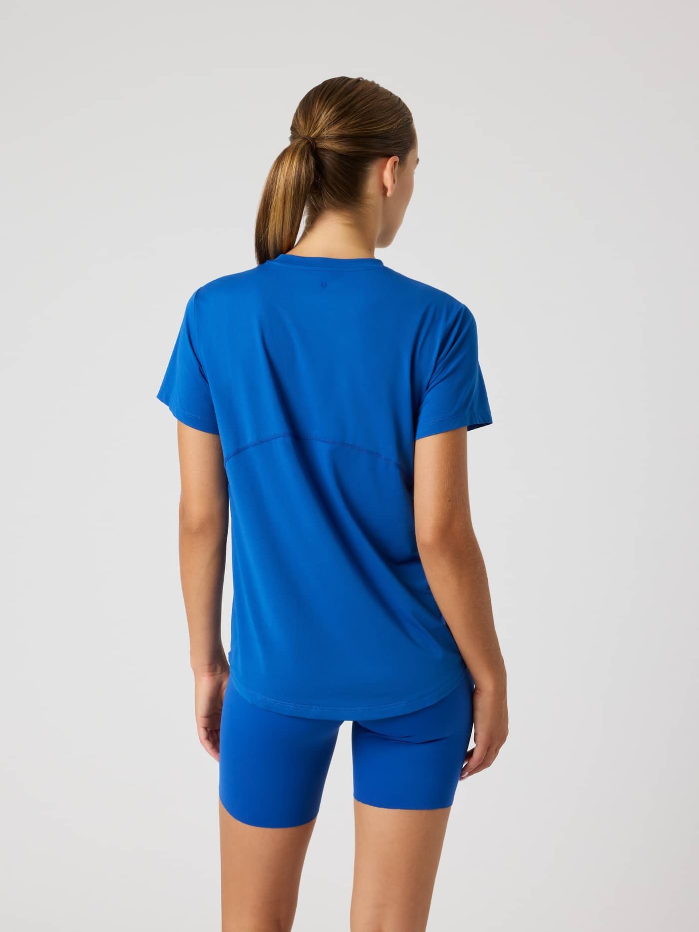 Back view of a model in the Monaco Blue (Blue) Borg Sports T-Shirt, a short sleeve training top with a stylish back seam. - Image 2