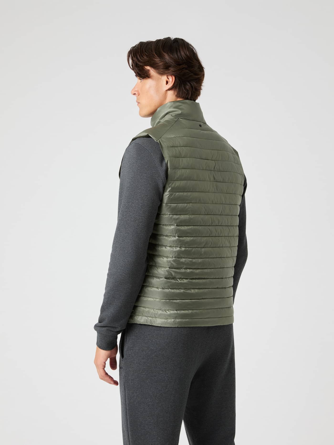 Back view of a man wearing the Borg Light Padded Vest in Dusty Olive (Green), showing its streamlined fit and function. - Image 3