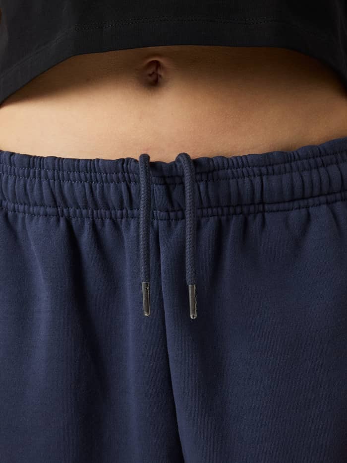 Detailed close-up of the drawstring waistband on the Borg Oversized Sweatpants in Odyssey Gray (Navy) for kids. - Image 5