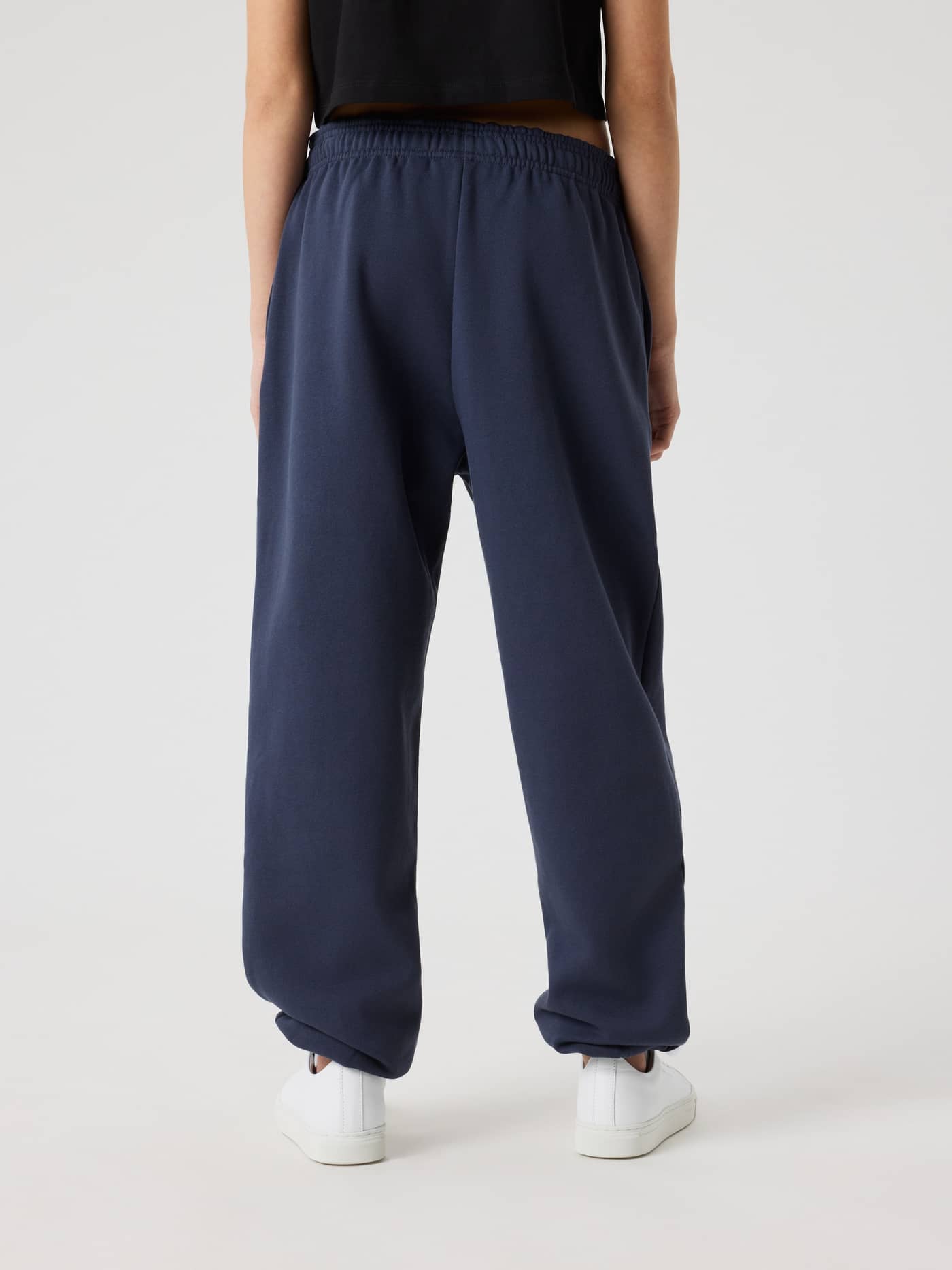 Back view of a kid wearing the Borg Oversized Sweatpants in Odyssey Gray (Navy), featuring a relaxed oversized fit. - Image 2