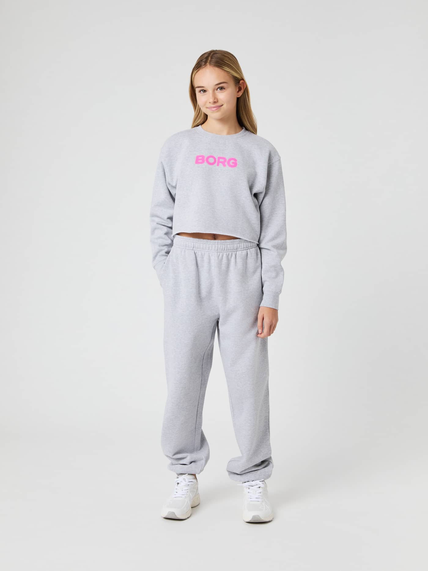 Full-body front view of a kid wearing the Borg Oversized Sweatpants in Light Grey Melange (Grey) with a relaxed kids' fit. - Image 3