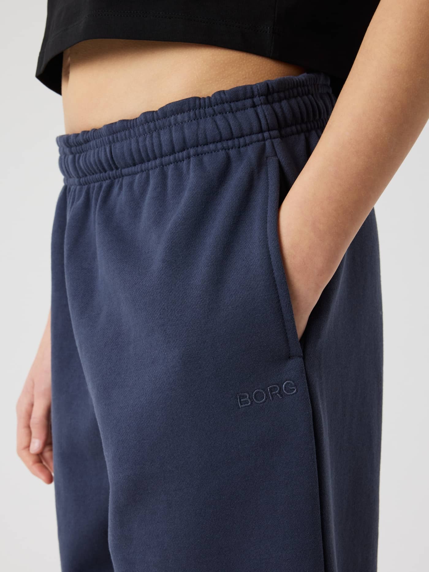 Borg Oversized Sweatpants in Odyssey Gray (Navy) for kids, shown in a side close-up with a tonal embroidered logo. - Image 4
