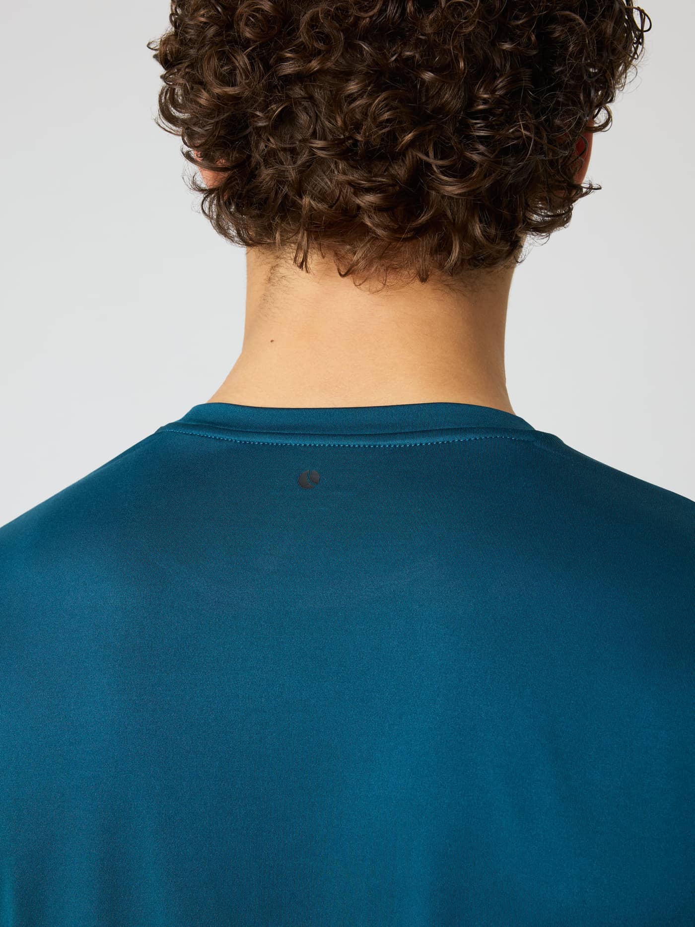 Close-up back view of the Borg Long Sleeve T-Shirt in Reflecting Pond (Green) with a black tennis ball training logo. - Image 5