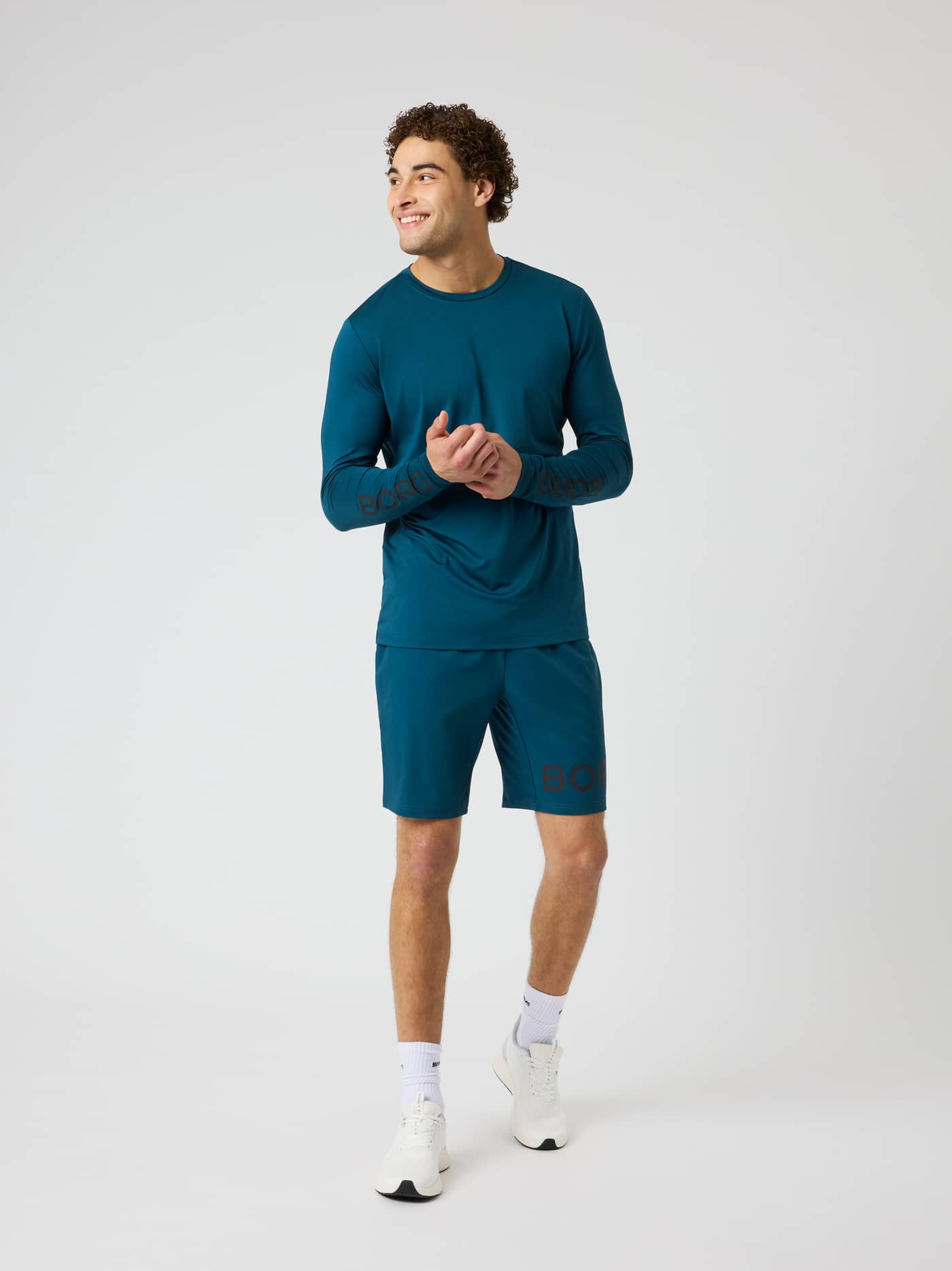Full-body view of the Borg Long Sleeve T-Shirt in Reflecting Pond (Green) for training with dark sleeve logo details. - Image 4