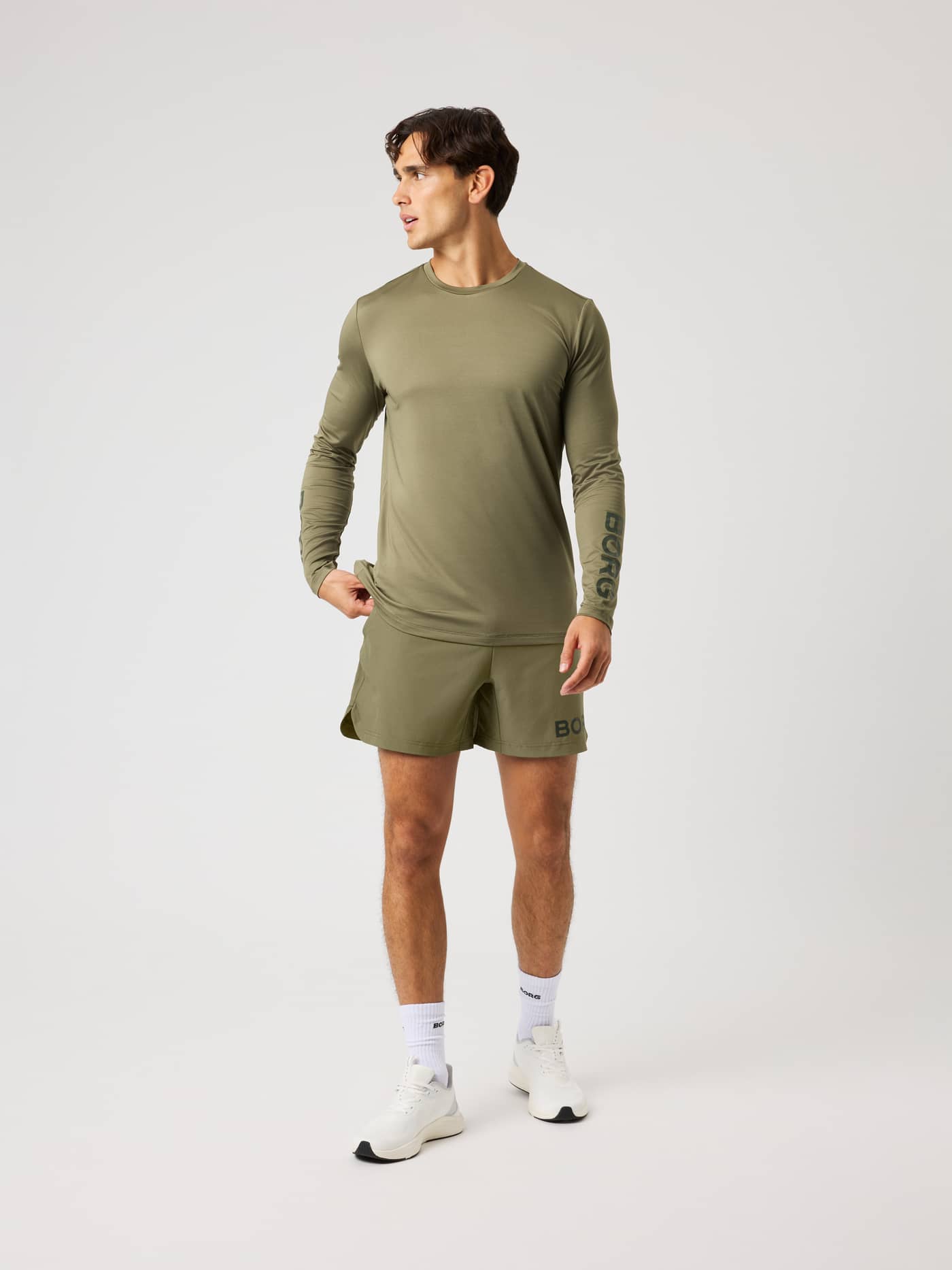 Front view of a model wearing the Borg Long Sleeve T-Shirt in Kalamata (Green) for a technical training look. - Image 4