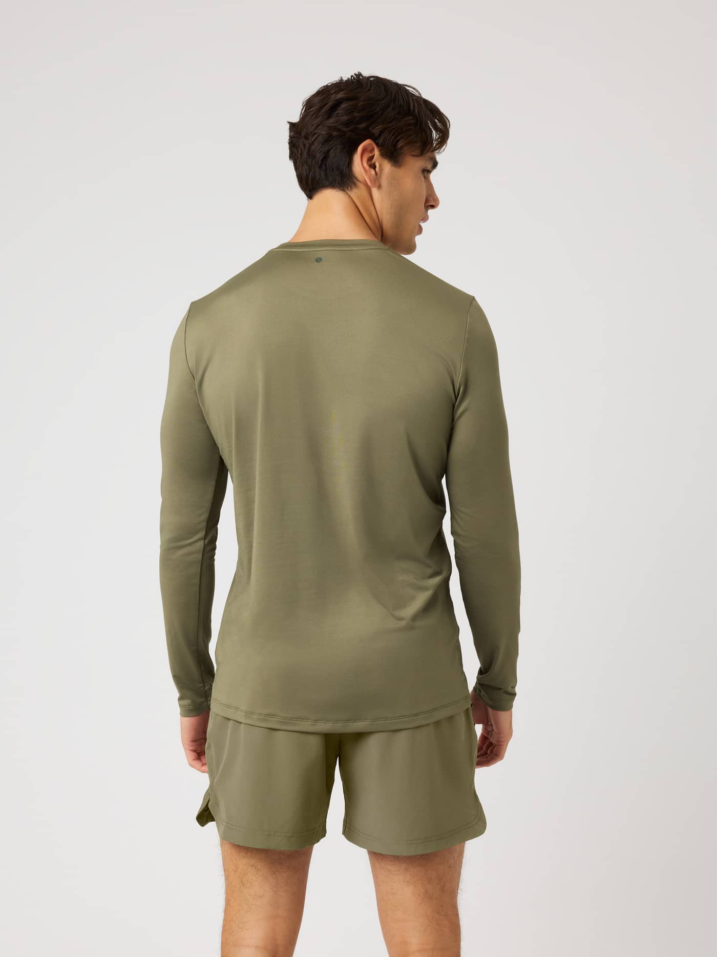 Back view of a model wearing the Borg Long Sleeve T-Shirt in Kalamata (Green), designed for performance training. - Image 3