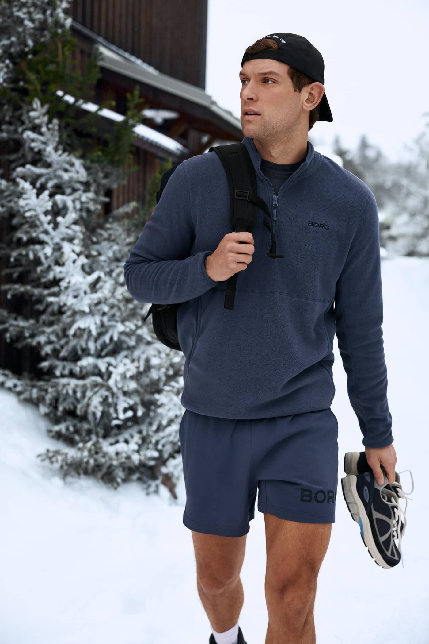 Man in Borg Half Zip Fleece in Odyssey Gray (Blue) with a black logo, a recycled polyester midlayer for style and function. - Image 2