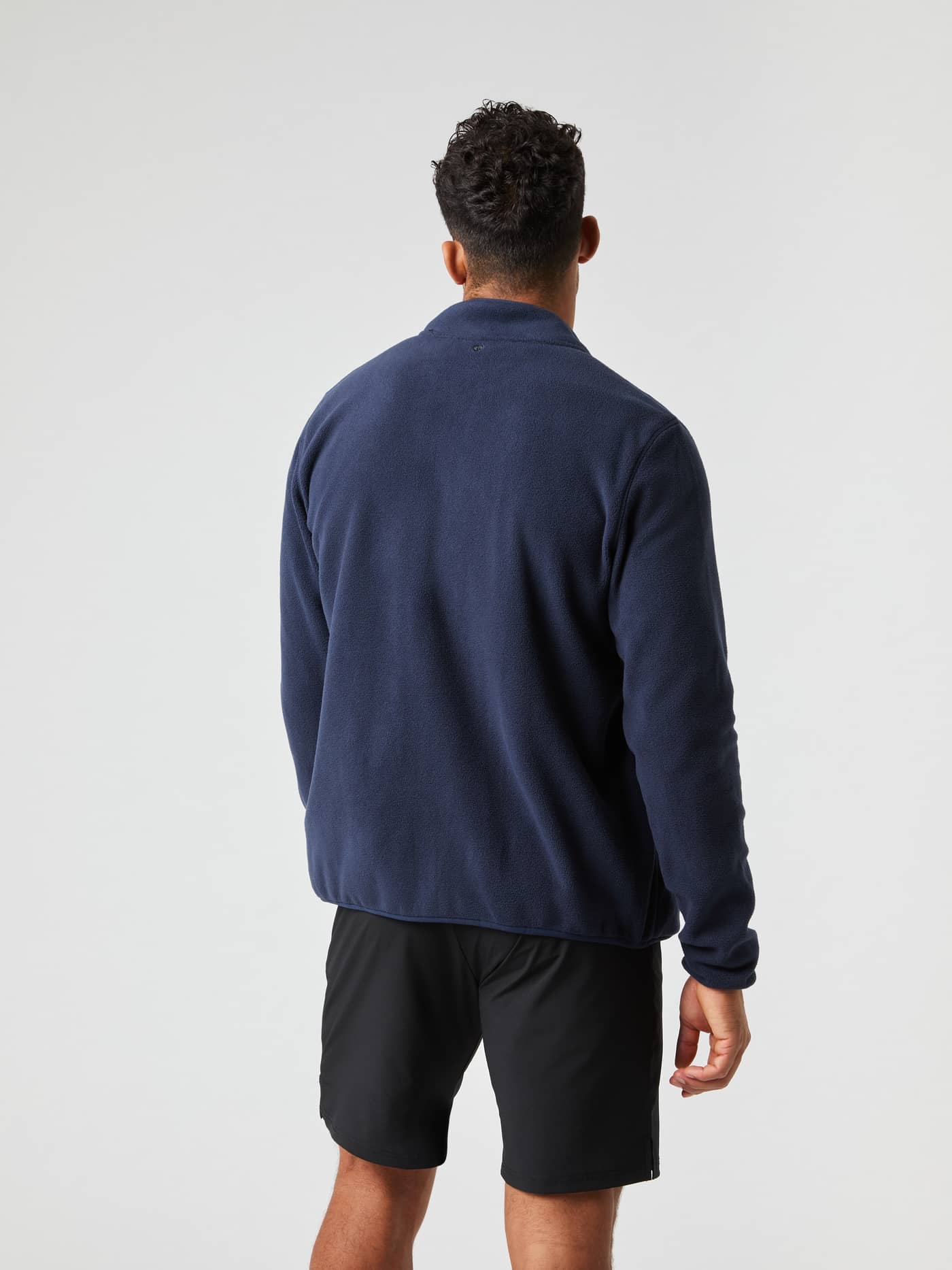 Back view of a man wearing the stylish and functional Björn Borg Full Zip Fleece in Night sky (Navy). - Image 3