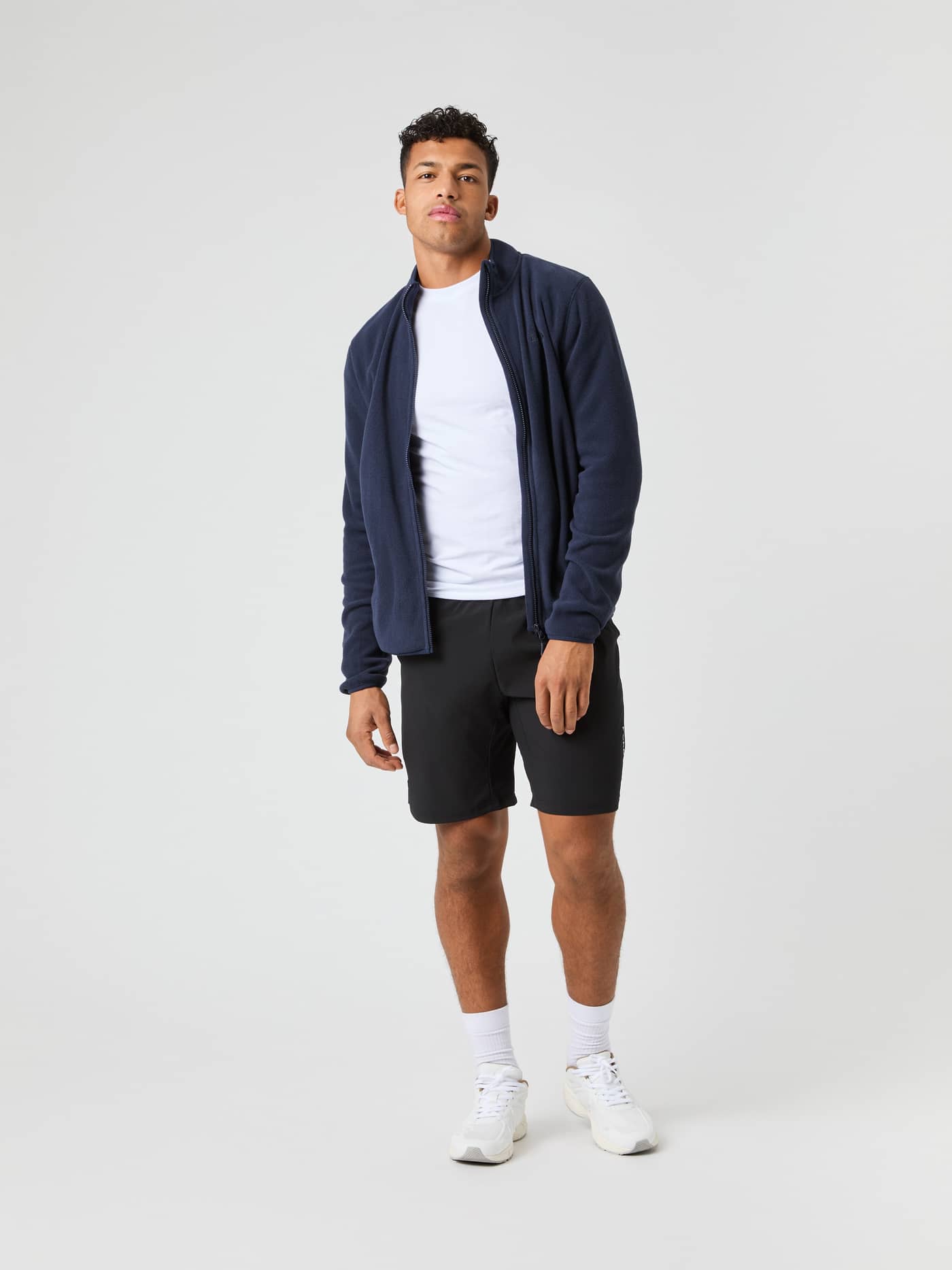 Full-body front view of a man wearing the Björn Borg Full Zip Fleece in Night sky (Navy) for functional style. - Image 1