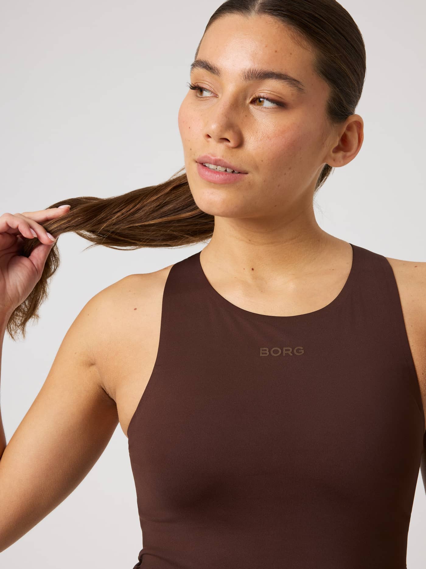 Close-up front view of the Borg 2 In 1 Tank Top in Coffee Bean (Brown) featuring a tonal brown logo for training. - Image 5