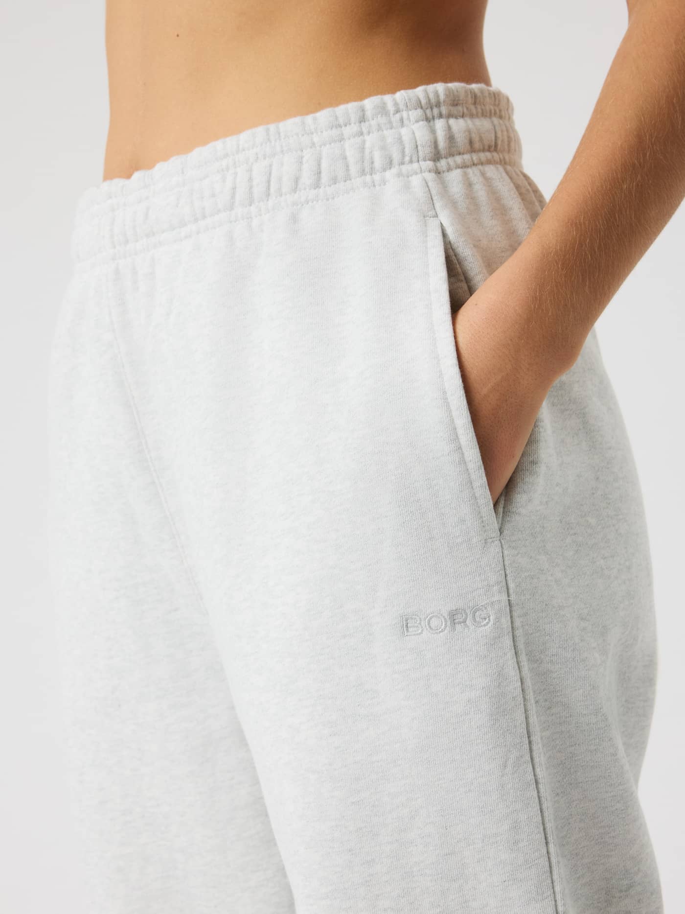 Close-up of Studio Oversized Sweatpants in Ultra Light Grey Melange (Grey) with a high-waisted fit and tonal BORG logo. - Image 4