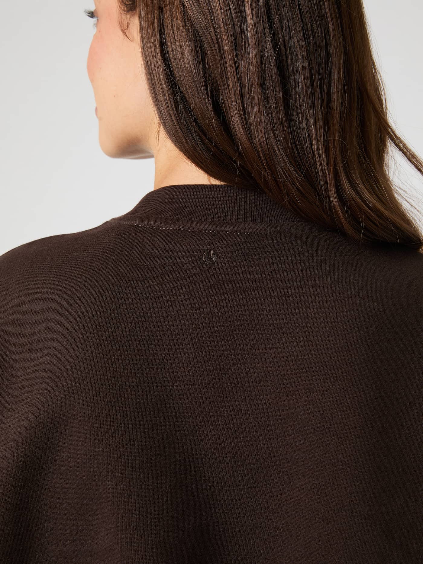 Close-up back view of the Studio Oversized Sweatshirt in Coffee Bean (Brown) featuring a tonal tennis ball print. - Image 4