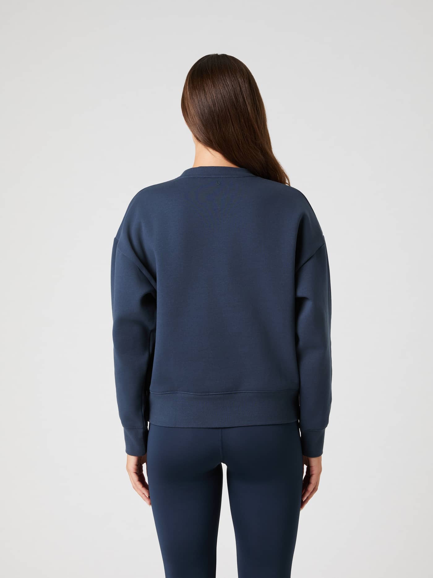 Back view of a woman wearing the Outerspace (Navy) Borg Boyfriend Sweatshirt with a stylish, oversized fit for leisure. - Image 3