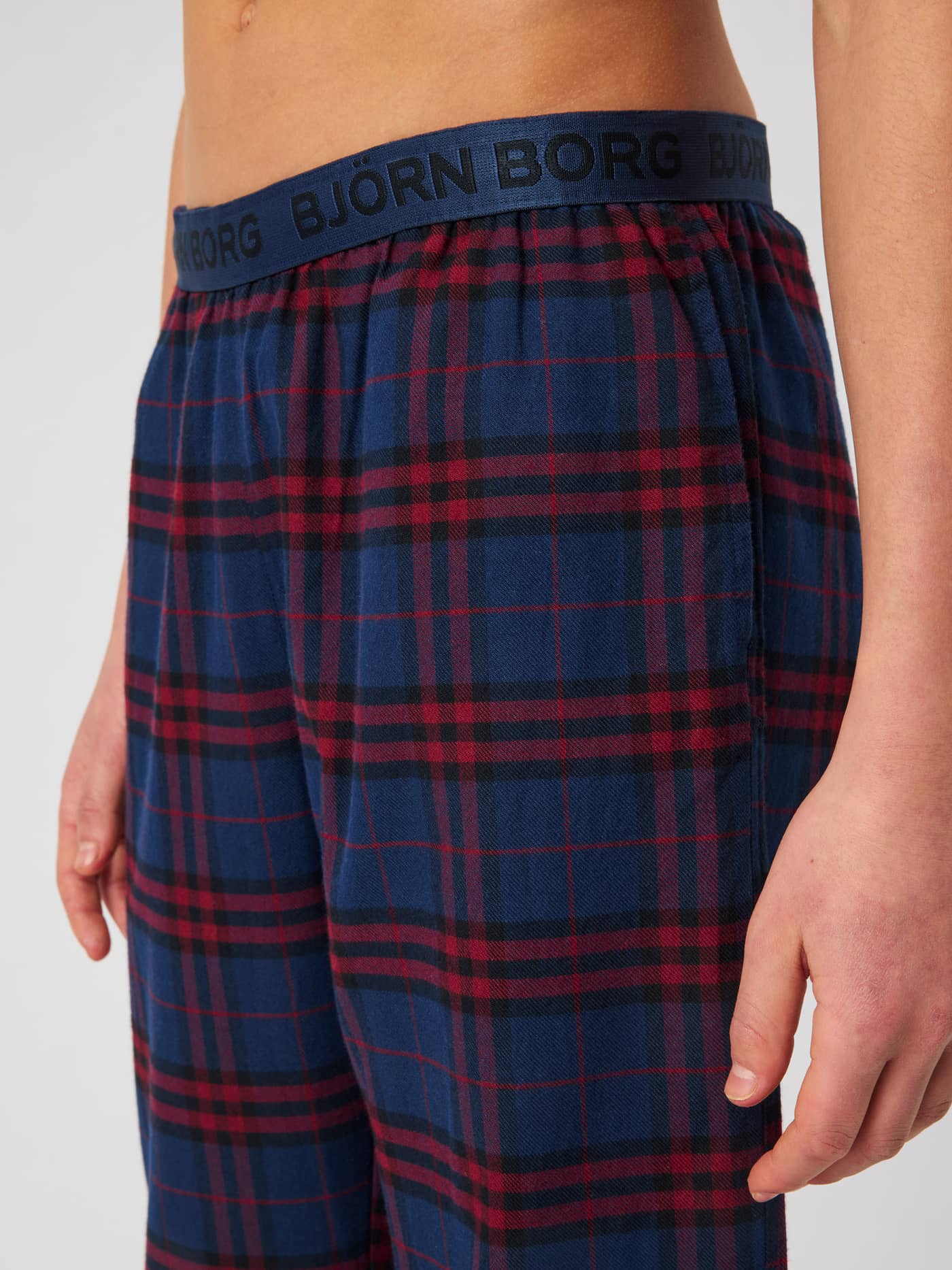Close-up of the Core Pyjama Pants in a blue and red tartan pattern, featuring an elastic waistband with the Björn Borg logo. - Image 3