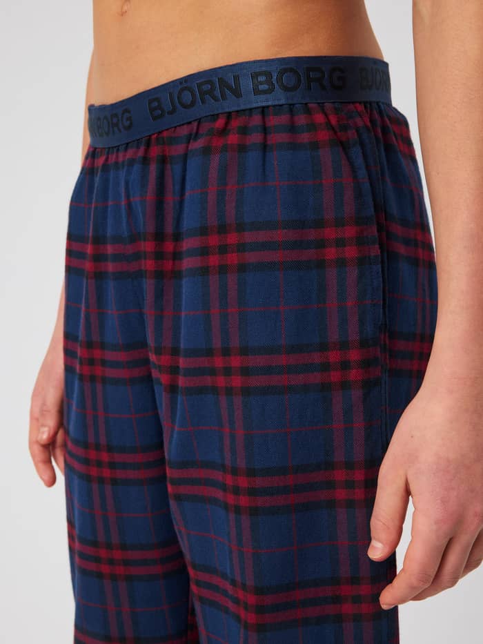Close-up of the Core Pyjama Pants in a blue and red tartan pattern, featuring an elastic waistband with the Björn Borg logo.