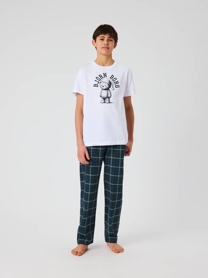 Front view of a kid wearing Core Pyjama Pants with a tartan check pattern.