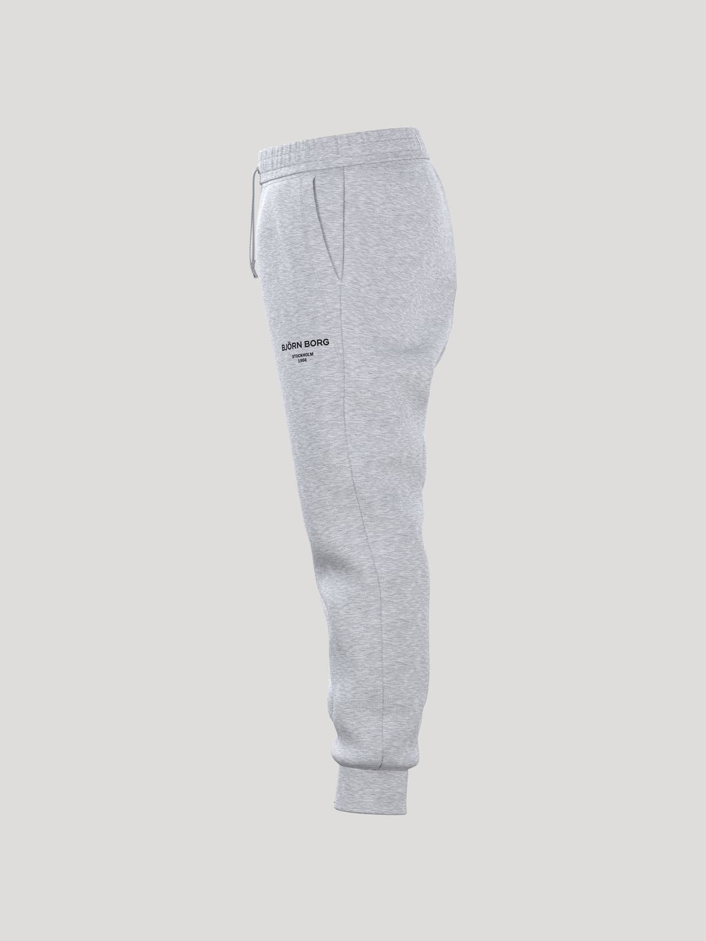 Side view of the Borg Essential 1 Sweatpants in light grey melange, pictured against a grey background. - Image 4