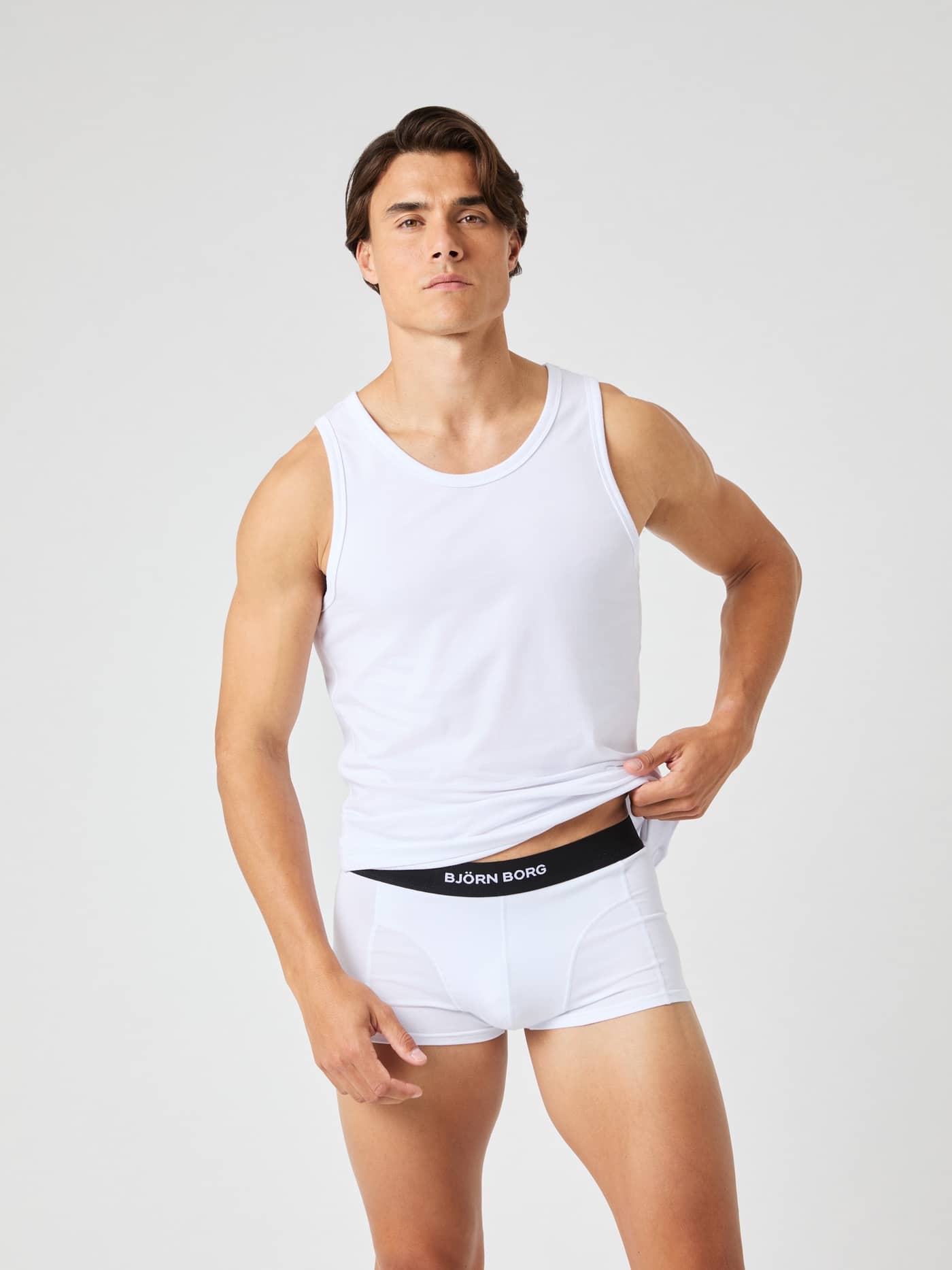 Front view of a man wearing the Björn Borg Core Slim Tank 2-pack in Brilliant White (White) cotton for a stylish slim fit. - Image 2