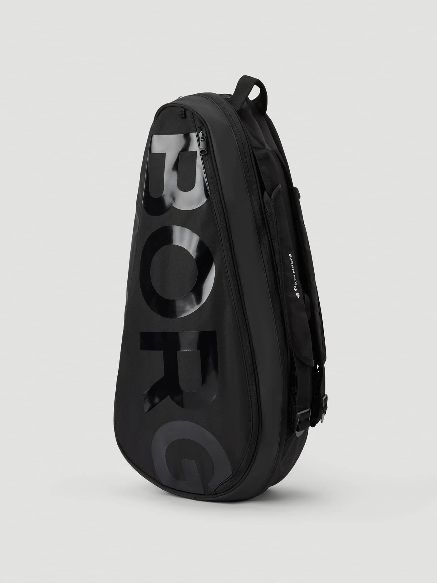 Side view of the Ace Tennis Bag in Black Beauty (Black), featuring a durable polyester build and glossy black BORG logo. - Image 1