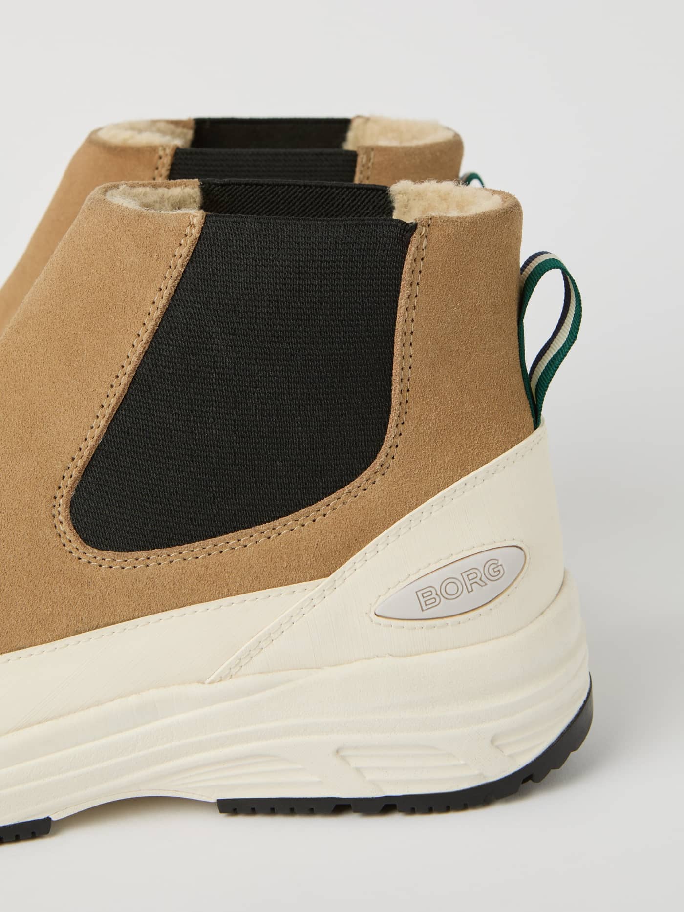 Detailed close-up of the Men's Chelsea Tech Boots in beige suede, featuring a silver BORG logo and elastic side panel. - Image 4
