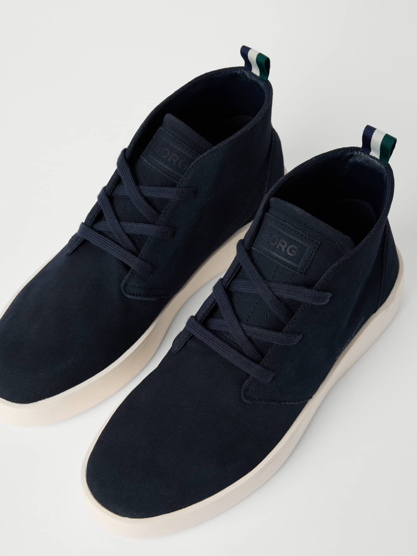 Angled view of navy Men's Desert Chukka Sneakers in suede, featuring a tonal BORG logo, refined style, and a comfortable fit. - Image 2