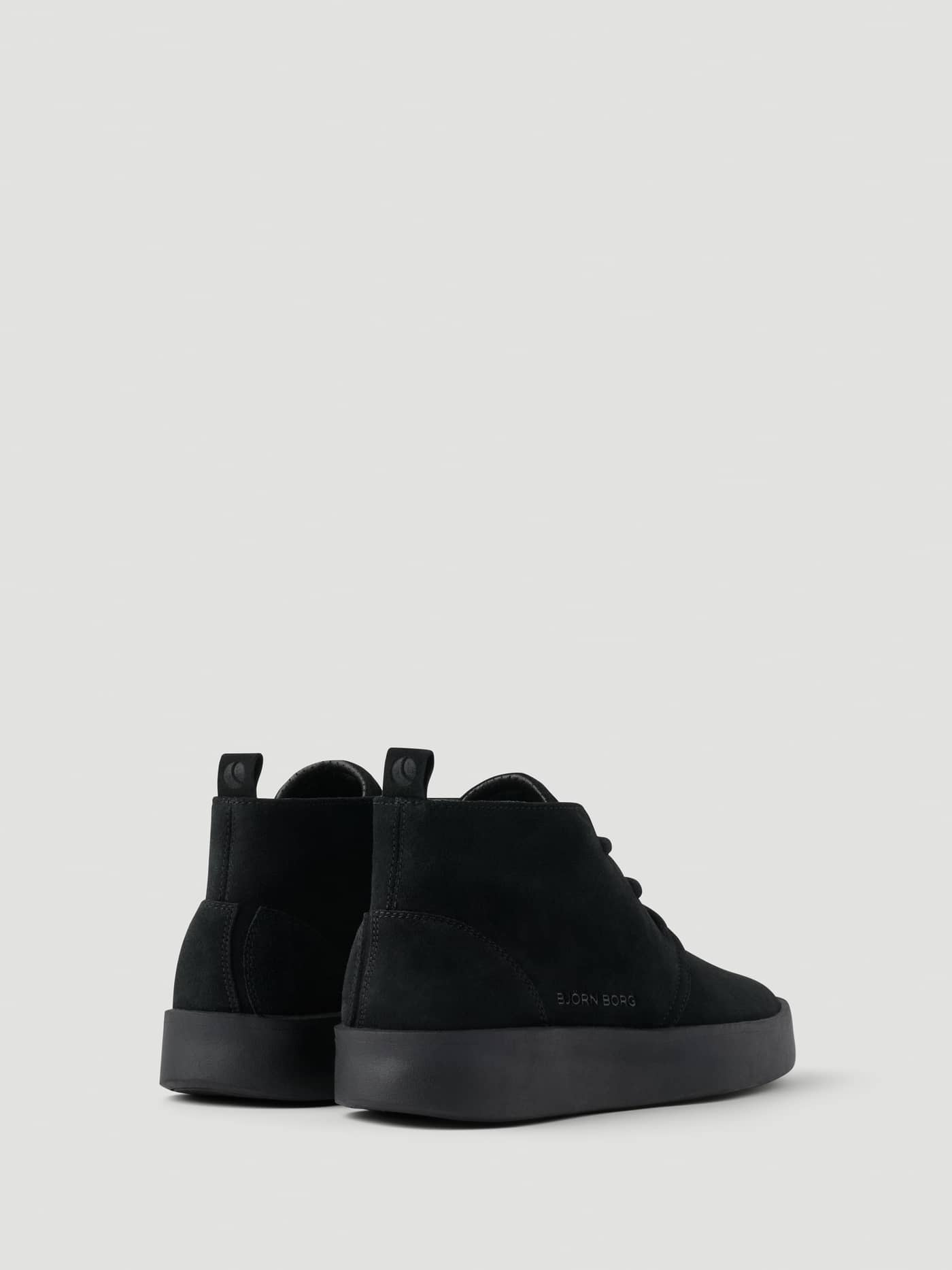 Men's Desert Chukka Sneakers in black suede, shown from the back with a tennis-inspired silhouette and black logo. - Image 3