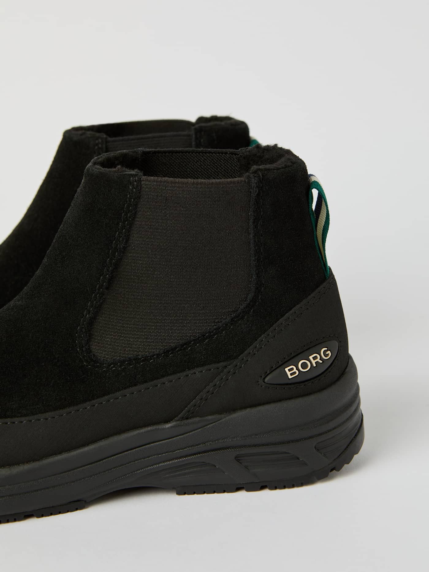 Detailed side view of the Women's Chelsea Tech Boots in black suede, highlighting the BORG logo and heel pull tab. - Image 4